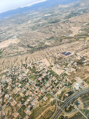 Obraz premium An impressive aerial panorama captures the vast, varied terrain of Alicante, Spain, revealing a patchwork of cultivated fields