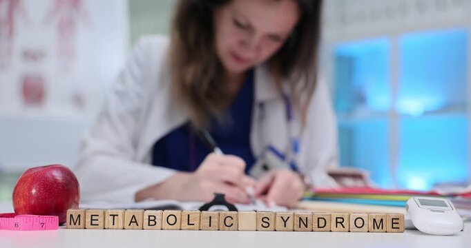 Physician writes detailed treatment plan in document. Wooden cubes arranged on table form phrase Metabolic Syndrome near apple and measuring tape