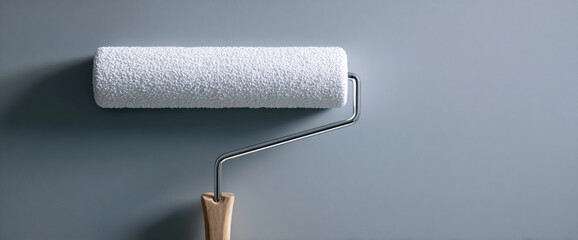 Obraz premium White paint roller on gray background