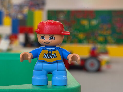 Smiling lego duplo figure with red cap