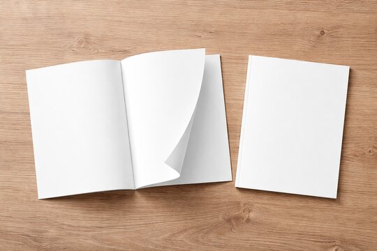  Blank magazine or brochure mockup with open pages and closed cover on a wooden table background. Template for design presentation.