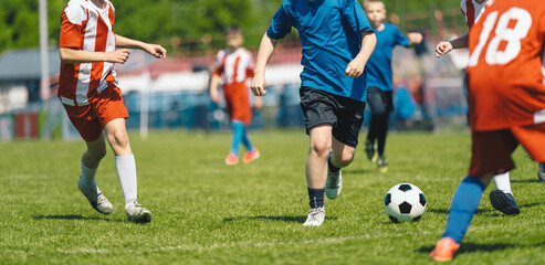 Youth Soccer Match Action – Kids Competing for Ball During Outdoor Football Game © matimix