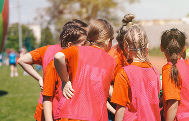 Youth Soccer Team Huddle, Kids in Training Bibs Listening to Coach During Football Practice