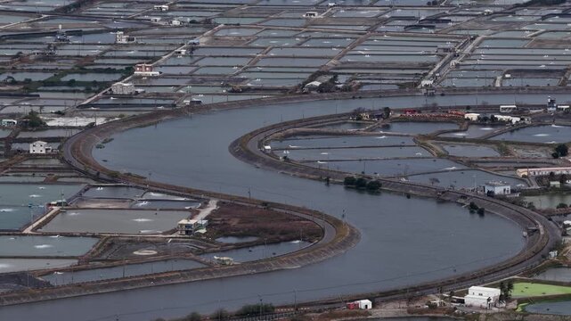 Aerial view of aquaculture fish farms and meandering river