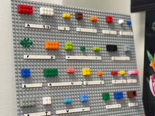 Obraz premium Colorful lego brick organizer on gray pegboard