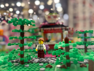 Obraz premium Lego minifigure in miniature park with trees and pavilion