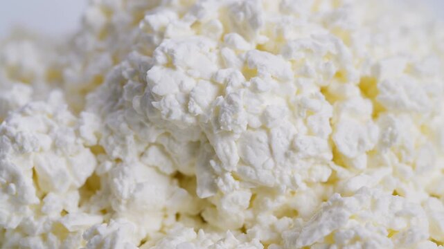 Closeup of creamy white curds, Macro photograph showcasing soft yellow whey in cheese curds, High resolution image emphasizing delicate structure of fresh dairy lumps and whey
