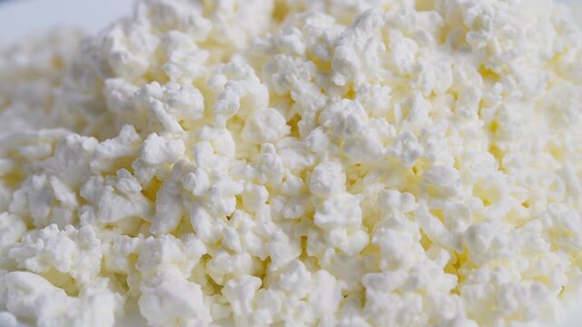 Detailed image of creamy curds and delicate whey particles, Highresolution photograph capturing intricate textures of cottage cheese and whey in culinary context