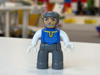 Obraz premium Gray and blue toy figure on white surface