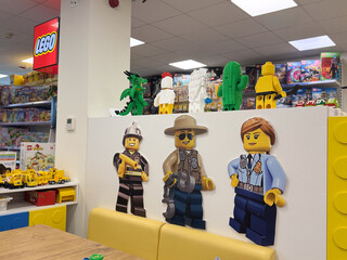Obraz premium Bright lego store play area with oversized minifig wall art