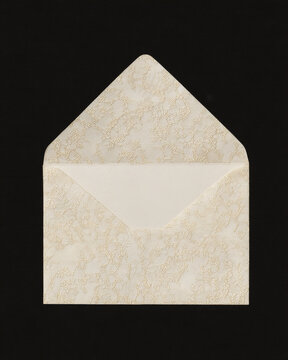 Wedding stationery mockup &ndash; Ivory embossed envelope with open flap on black background