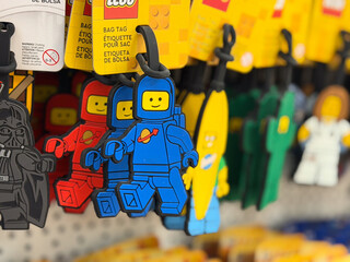 Obraz premium Colorful lego minifigure bag tags on display