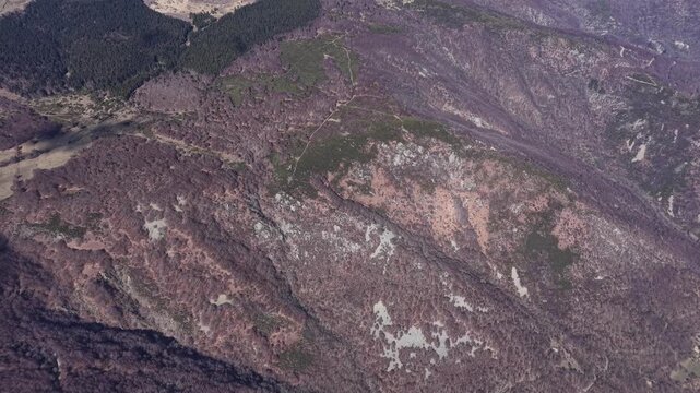 Oblique drone view showing textured rocky slope with sparse vegetation in Montpezat-sous-Bauzon, Ard&egrave;che, France