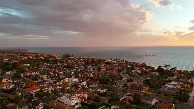 Aerial view of Southwest San Clemente at sunset, showing hillside homes, coastal streets, the Pacific shoreline, and San Mateo Rocks in the distance along the Southern California coast.
