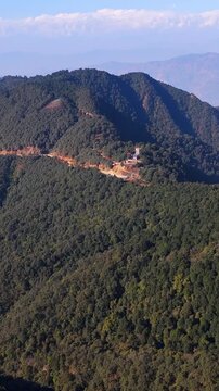 Winding dirt road carved into the Himalayan foothills near Kathmandu, Nepal