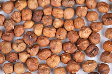 Fototapeta premium Elegant arrangement of natural hazelnuts emphasizing artistic texture and style. Stylistic presentation of rustic hazelnuts with matte finishes in artistic culinary display