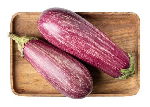 Graffiti eggplant. Two graffiti aubergine on wooden plate isolated on white. Top view.