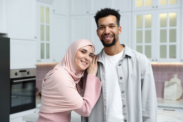 Fototapeta premium Portrait of happy muslim couple in kitchen
