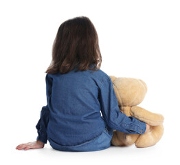 Autism. Little girl with teddy bear on white background, back view © New Africa