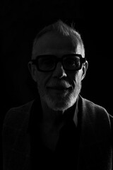 Fototapeta premium head shot dark portrait of a mature man looking at camera