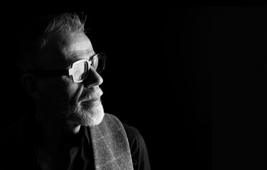 Profile portrait, headshot of a mature man in low key, black and white © Curto