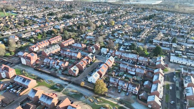 Aerial view of Barton Seagrave suburban streets and rooftops with countryside beyond Northamptonshire England
