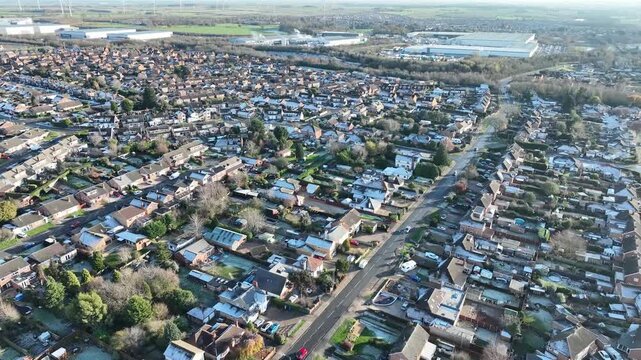 Wide aerial panorama of Barton Seagrave village and Kettering suburbs on sunny day Northamptonshire England