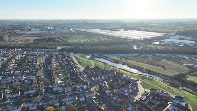 Aerial view of Barton Seagrave village rooftops with green spaces and ponds Northamptonshire England