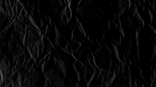 Black Wrinkled Paper Texture Background Loop. Close-up of a dark, crumpled paper surface with grunge animation.