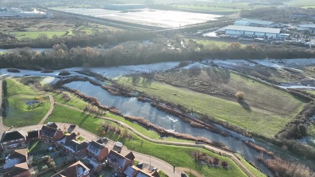 Aerial view of Barton Seagrave outskirts with flooded fields and industrial area Northamptonshire England
