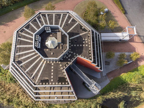 Aerial view of the distinctive octagonal building with geometric patterns and connecting walkways, Gooisekant, Flevoland, Netherlands.