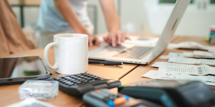 White mug calculator laptop desk business budget work focus finance man office receipt paper document device technology