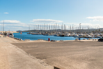 Obraz premium La Caletta harbor in the municipality of Posada, one of the main tourist marinas on the eastern coast of Sardinia, Italy. Mediterranean port with boats and coastal scenery.