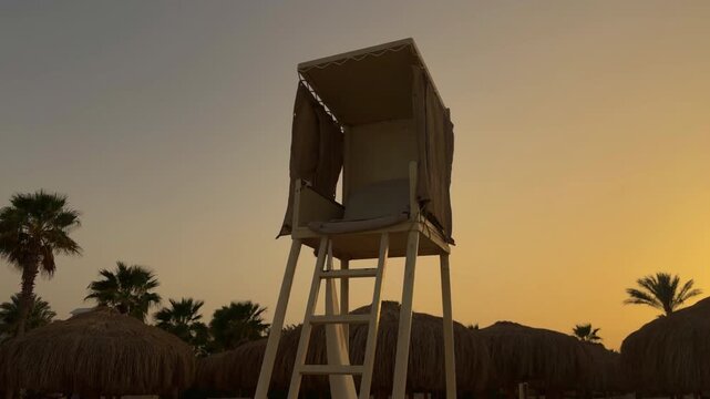 Dusk Over Deserted Surfside Tower. Calm Beach Scene With Empty Lookout And Setting Sun