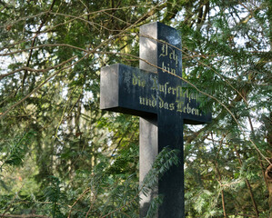 schwarzes Kreuz mit einem frommen Bibelspruch auf einem Friedhof in Unna © Blende8
