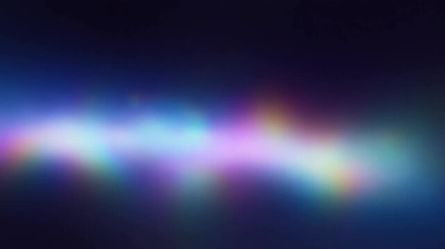 Slow motion tracking pan of colorful light flare drifting across dark background with rainbow glow and soft gradient abstract studio space