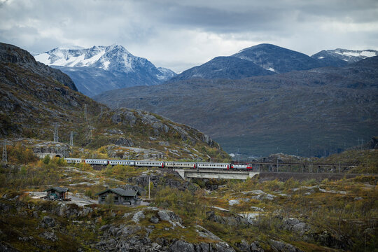 Beautiful view of train moving on tracks overlooking scenic mountains