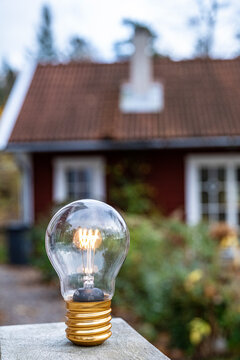 Glowing light bulb kept on outdoor table