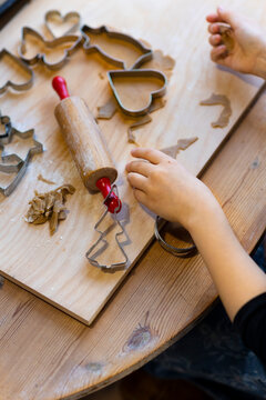 High angle view of unrecognizable person making different shape of cookies on board