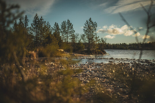 Low angle view of pebbles at shore of sea on remote location