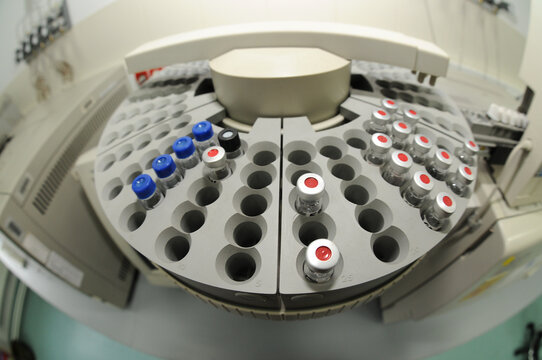 Sample vials on Gas Chromatograph autosampler in a police forensic laboratory