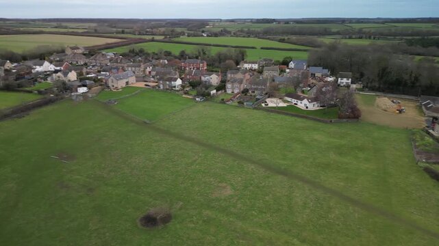 Wide aerial panorama of Twywell village and Northamptonshire countryside with patchwork fields