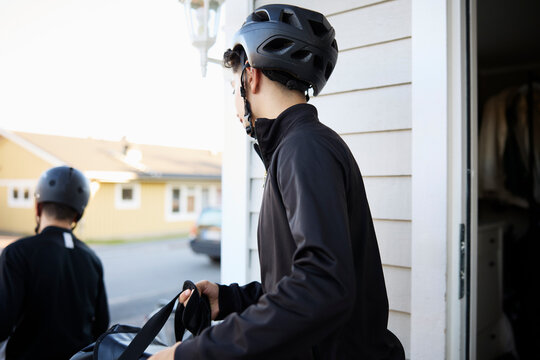 Side view of boy wearing helmet while going for golf session