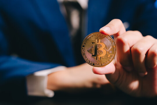 Golden coin cryptocurrency digital currency finance investment business hand person technology economy wealth money financial market blockchain
