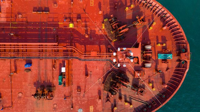 Massive oil tanker ship at maritime loading terminal for global energy logistics and petroleum freight transport. International cargo supply chain, crude oil export, and industrial 