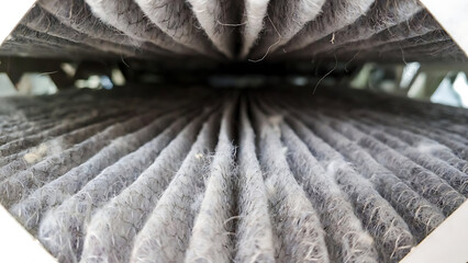 furnace, filter, air, technician, hvac. Close-up image of a heavily dust-clogged air filter showing accumulated fibers and dirt in a vehicle or HVAC system.