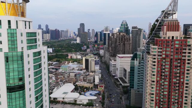 Bird's eye view showcasing Berkeley Hotel Pratunam and busy traffic flow on a major roadway slicing through the crowded cityscape of Bangkok, Thailand. Bangkok, Thailand May 2. 2025