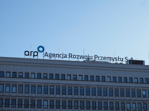 Corporate headquarters of Agency for Industry Development with blue signage against clear blue sky