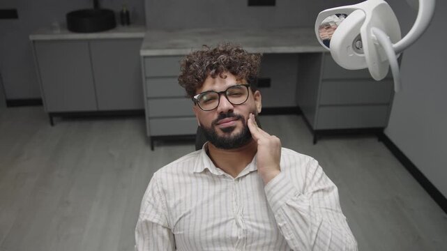 Patient touching sore cheek suffering from toothache cavities or gingivitis waiting for dentist appointment gums disease