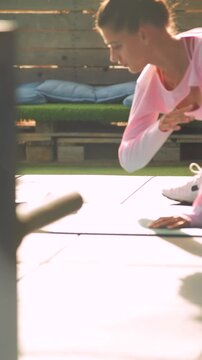 Young lady practicing oblique and core exercises in park setting
